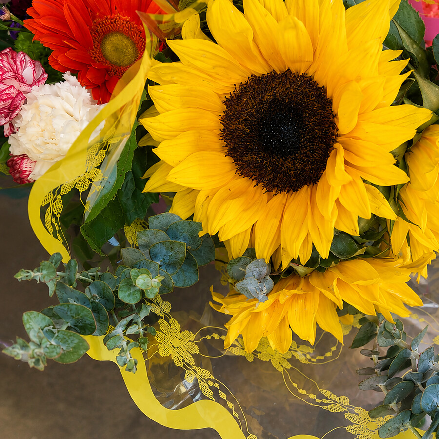 Close up of a bright sunflower in a mixed bouquet